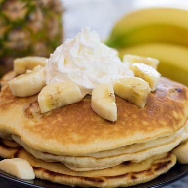 Banana pancakes are delicious with macadamia nuts and honey butter.